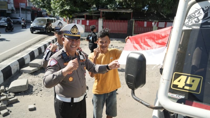 Kasat Lantas Polres Gowa Membagikan Bendera Merah Putih Kepada Pengendara